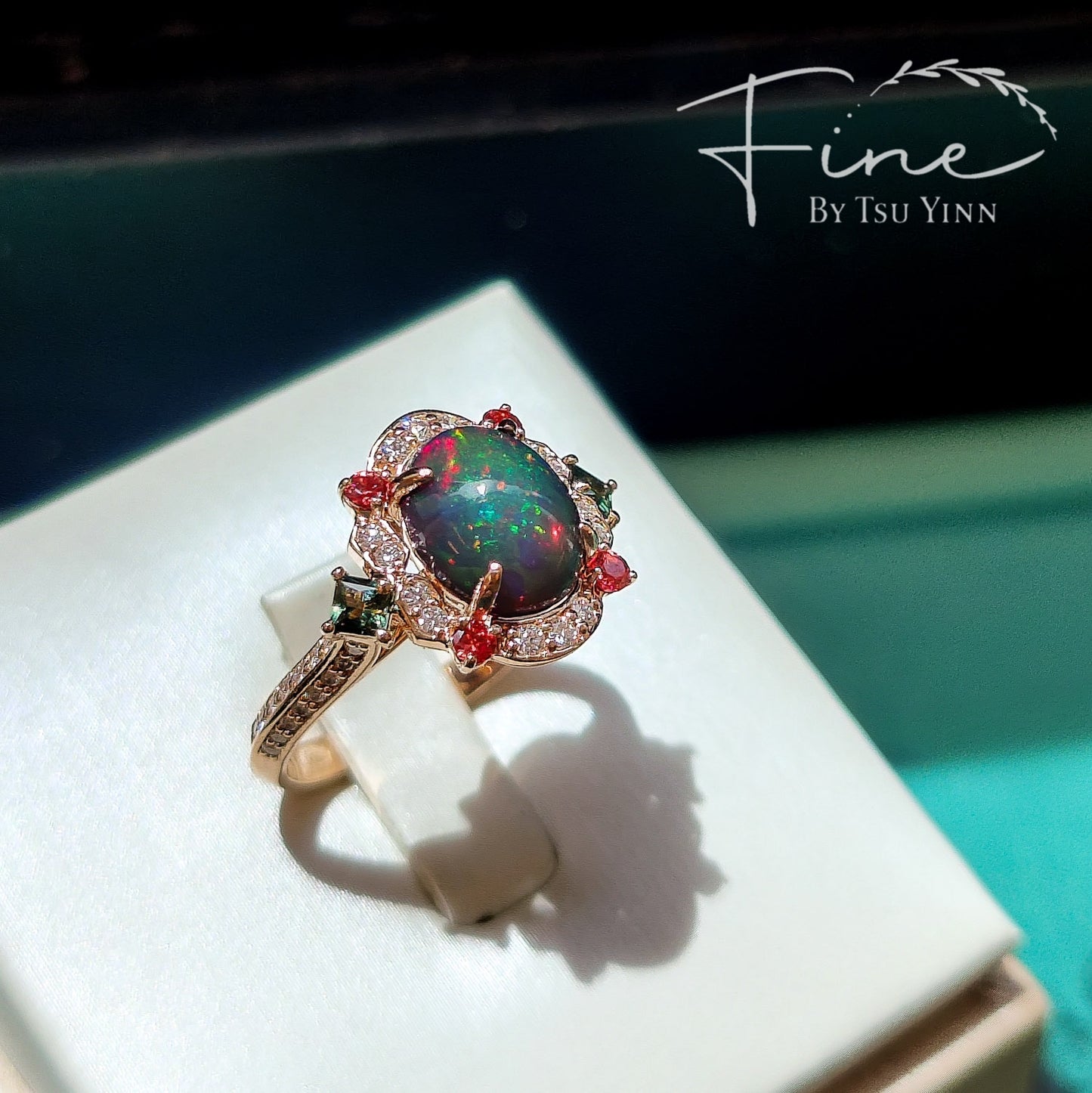 FBTY Kyra Ring with Black Opal Cabochon, Green Sapphires, Dark Orange Spinels and White Diamonds